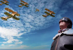 Pilot looks up at a squadron of biplanes