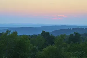 Pink evening sky over a gentle hilly landscape