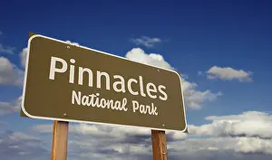 Pinnacles national park (california) road sign against blue sky and clouds