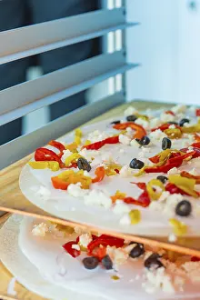 Pizza in the oven with peppers