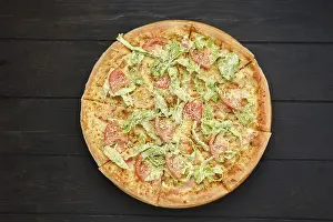 Pizza with squid, shrimps, parmesan and salad leaves