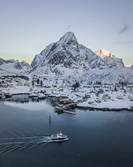 Place Reine voe snowy mountains with passenger boat