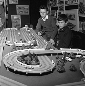 Playing in the 1950s. Two boys at a toy exhibition are playing with the new racing car track. Sweden 1962