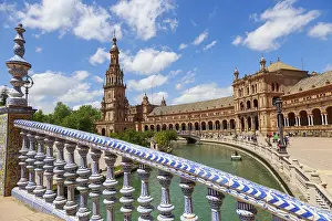 Plaza de Espana in Seville with magnificent architecture and bridge on a sunny day with clouds