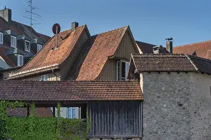 Pointed gable houses with tiled roofs and town wall with battlements