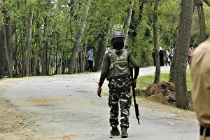 Policeman running Kashmiri students protesting