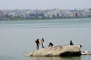 Poor people washing clothes in Hussain Sagar lake in Hyderabad