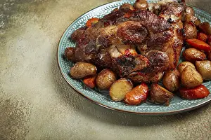 Pork knuckle baked with vegetables