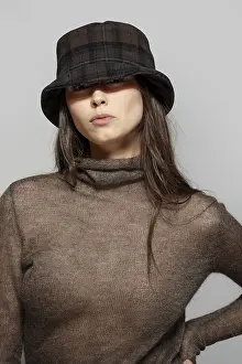 Portrait of beautiful girl in angora sweater and plaid wool hat