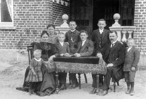Portrait, family sitting at a table and looking into the camera