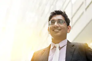 Portrait of handsome Asian Indian business man smiling