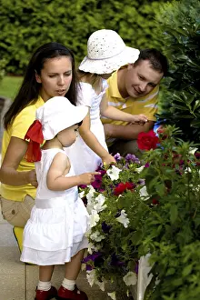 A portrait of a happy family of four persons in the summer garden