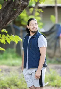 Portrait of a man standing looking at the horizon in the middle of nature outdoor
