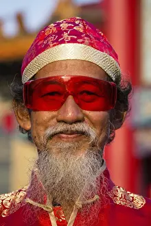 Portrait, old chinese man with red glasses