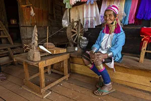Portrait of a Padaung, giraffe with a traditional weaving chair