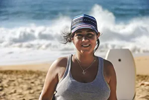 Portrait of smiling woman looking at the camera at the beach