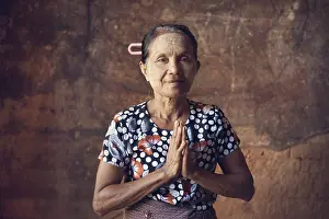 Portrait of traditional Asian Burmese woman praying