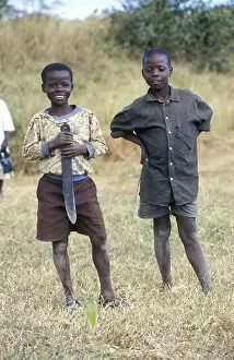 Portraits of two boys, one of them holding a large knife