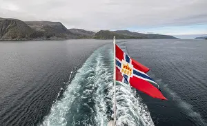 The post symbol on a Norwegian flag of a Hurtigruten ship
