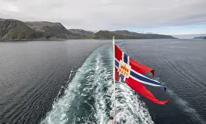 The post symbol on a Norwegian flag of a Hurtigruten ship