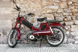 Powered two-wheeler in front of mediterranean wall