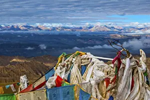 Prayer flags over the eroded mud landscape in the kingdom of Guge