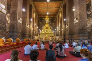 Prayer with monks in the Buddhist Phra Ubosoth
