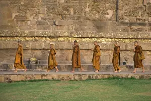 Praying Buddhist monks circling the Dhamekh stupa