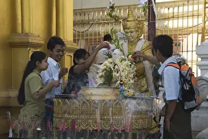 Praying worshippers make offerings to Buddha