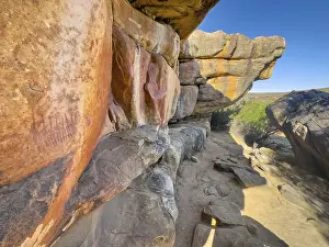 Prehistoric depiction of woman on a rock
