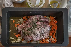 Preparation of a wild boar roast with spices and vegetables in a cast-iron casserole