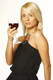 Pretty young blonde women with glass of red wine