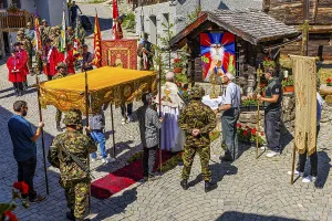 The priest celebrates a service at the flower-decorated altar during the Corpus Christi procession