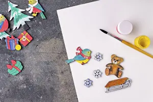 The process of painting wooden toys for the Christmas tree