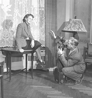 A professional photographer arranges the photo model Haide Goeranson so that he gets a good