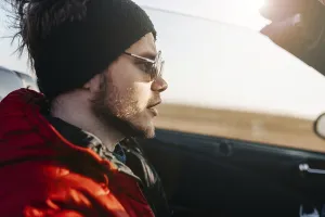 Side profile of a man in sunglasses in a convertible