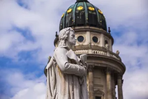 Profile shot of the Schiller statue with the French cathedral in the background