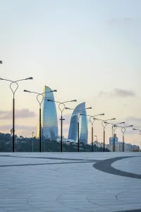 Promenade with flame towers behind in twilight