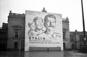 Propaganda, banner with Stalin at the ruins of the New Theatre