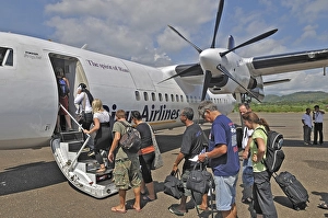 Propeller aircraft, prop jet Fokker 50, former Riau Airlines, passengers at the airport in Labuan Bajo, Flores Island, Indonesia, Asia