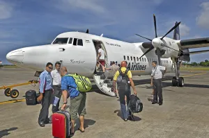 Propeller aircraft, prop jet Fokker 50, former Riau Airlines, passengers and staff at the airport in Labuan Bajo, Flores Island, Indonesia, Asia
