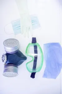 Protective items including mask and gloves on a white backdrop