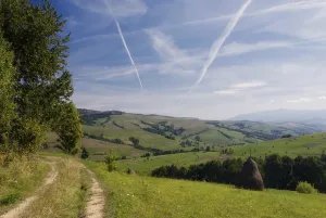 Purity of the sky with airplane's track and road in field<br> Purity of the sky with airplane's track