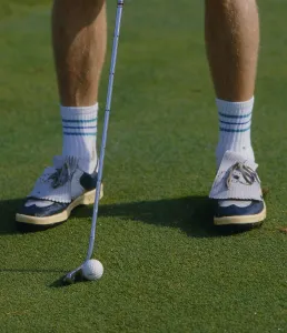 Putter and golf ball on the green