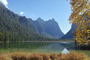 Framed Print : Quiet mountain lake against light