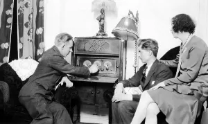 Radio, engineering history, two men and a woman listening to the radio