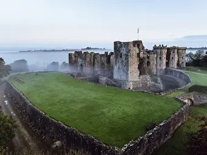 Raglan Castle in the fog at dawn from a drone