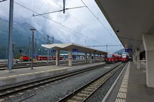 Framed Print : Railway Station and Red Train with Mountain View in a Cloudy Summer Day in Engadin Framed Print : Railway Station and Red Train with Mountain View in a Cloudy Summer Day in Engadin