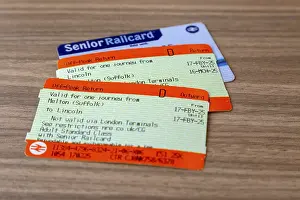 Railway train off-peak return tickets with Senior Railcard oblique angle view to table