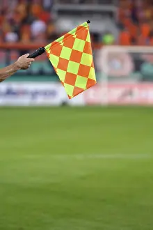 Raised sideline football referee flag in Lubin